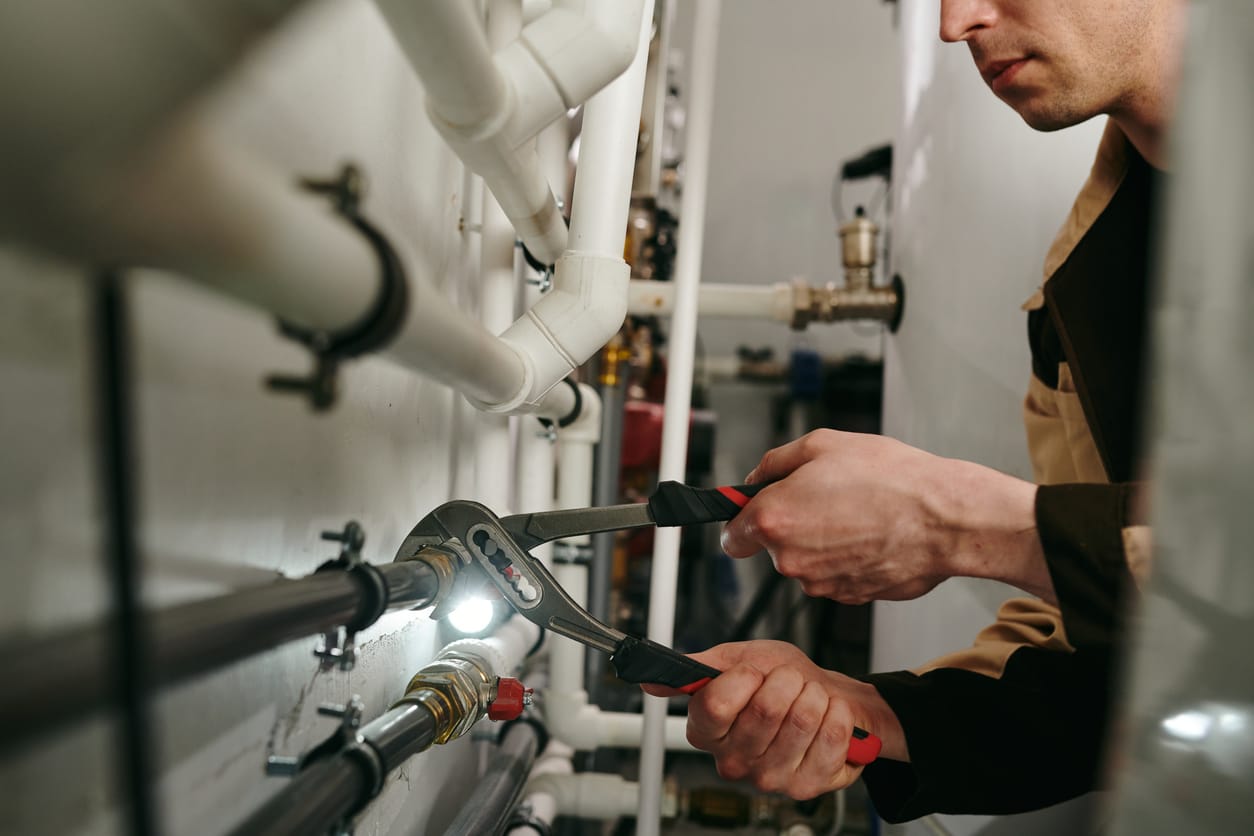 Plumbers maintaining commercial plumbing pipes in Englewood