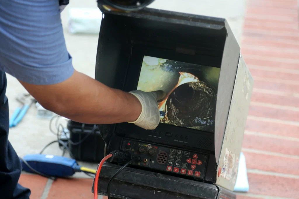 Technician viewing a drain inspection camera in Englewood